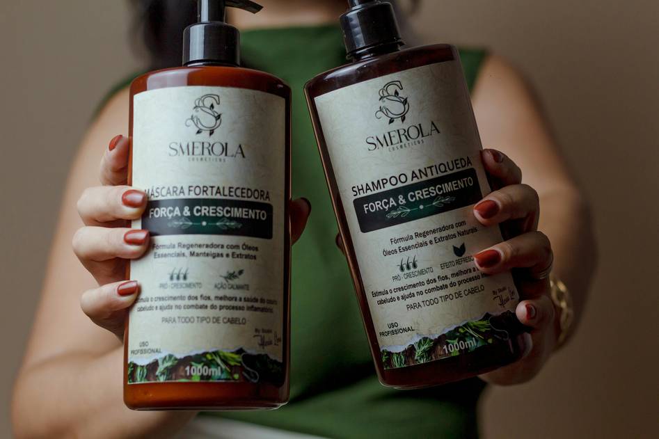 Assortment of hair thickening products and tools on a minimalist vanity with natural light